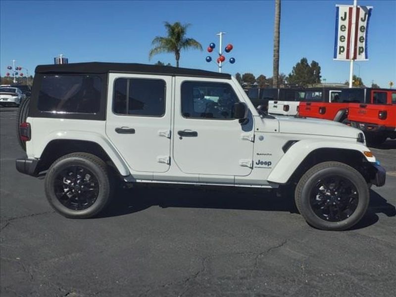 2024 Jeep Wrangler Sahara 4xe in a Bright White Clear Coat exterior color and Blackinterior. Perris Valley Auto Center 951-657-6100 perrisvalleyautocenter.com 