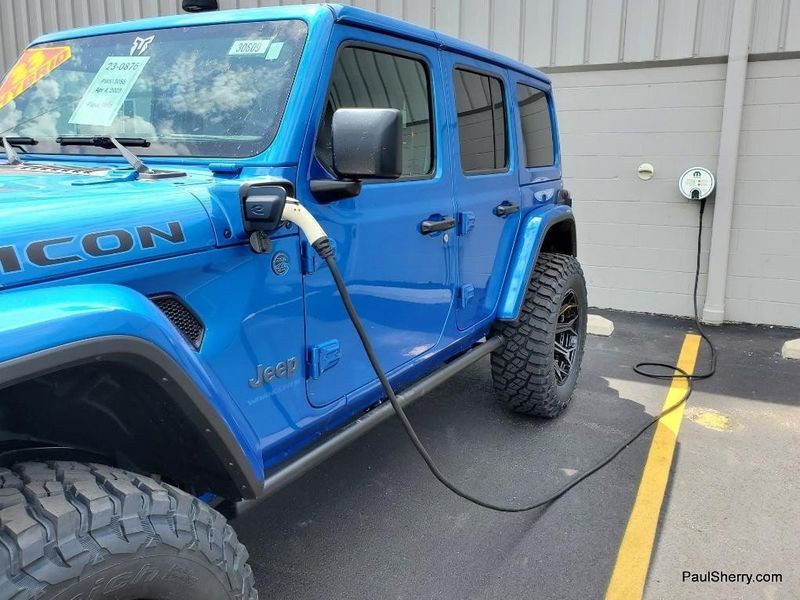 2023 Jeep Wrangler Rubicon 4xe in a Hydro Blue Pearl Coat exterior color and Black/Dark Saddleinterior. Paul Sherry Chrysler Dodge Jeep RAM (937) 749-7061 sherrychrysler.net 