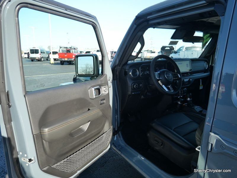 2024 Jeep Wrangler 4-door Sahara 4xe in a Anvil Clear Coat exterior color and Blackinterior. Paul Sherry Chrysler Dodge Jeep RAM (937) 749-7061 sherrychrysler.net 