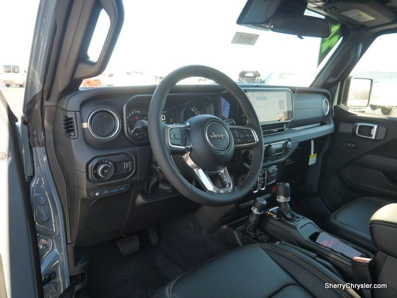 2024 Jeep Wrangler 4-door Sahara 4xe in a Anvil Clear Coat exterior color and Blackinterior. Paul Sherry Chrysler Dodge Jeep RAM (937) 749-7061 sherrychrysler.net 