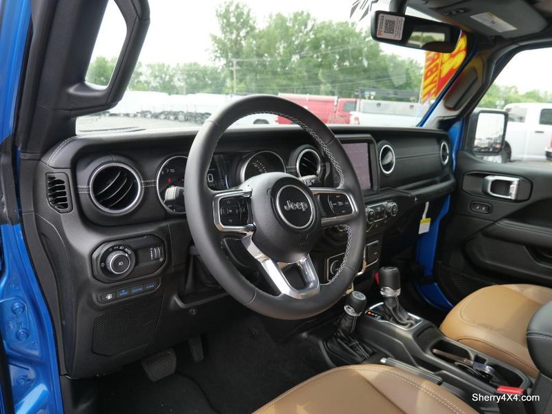 2023 Jeep Wrangler Rubicon 4xe in a Hydro Blue Pearl Coat exterior color and Black/Dark Saddleinterior. Paul Sherry Chrysler Dodge Jeep RAM (937) 749-7061 sherrychrysler.net 