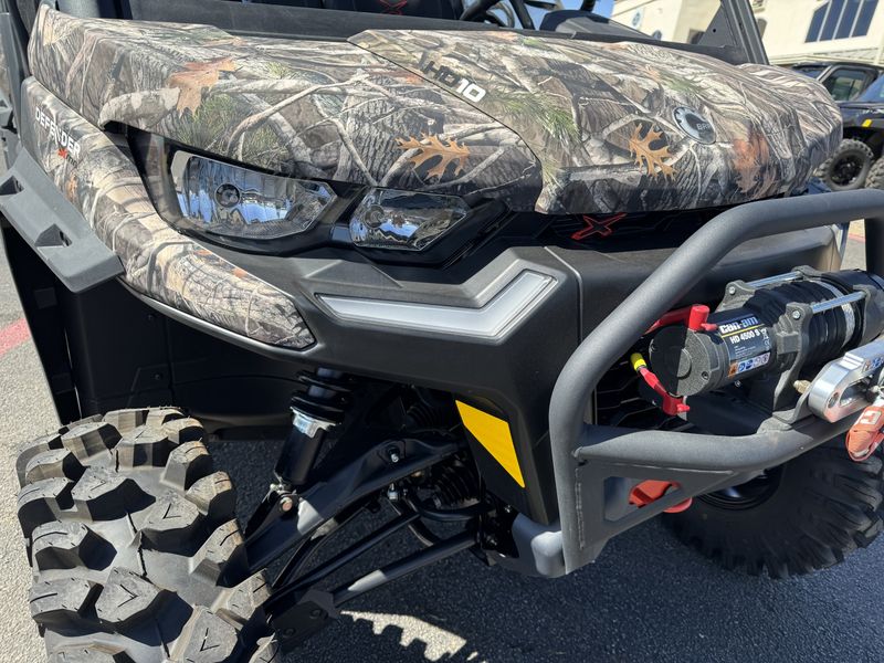 2024 CAN-AM DEFENDER MAX X MR HD10 CAMO WILDLAND in a CAMO exterior color. Family PowerSports (877) 886-1997 familypowersports.com 