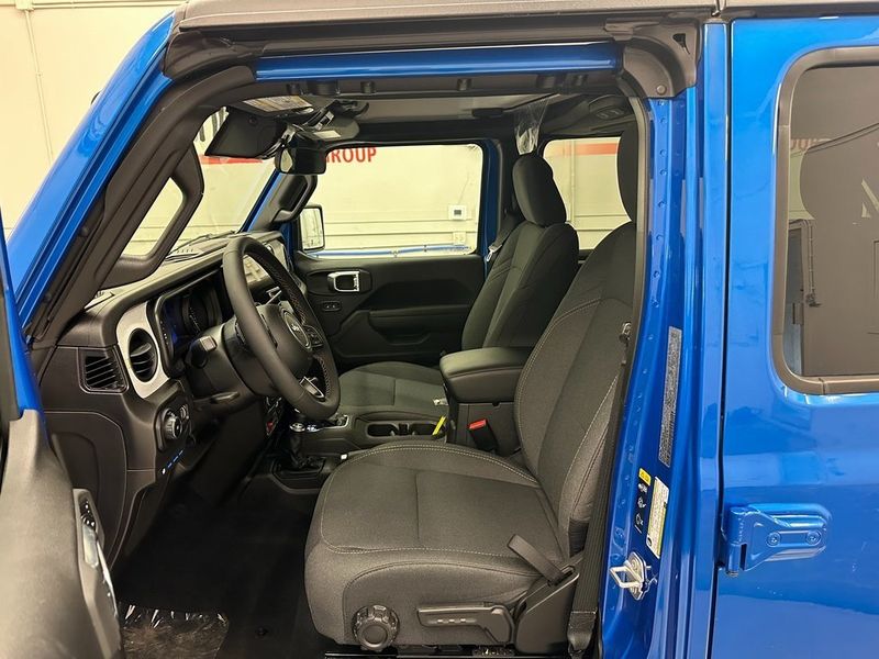 2024 Jeep Wrangler 4-door Willys 4xe in a Hydro Blue Pearl Coat exterior color and Blackinterior. Marina Auto Group (855) 564-8688 marinaautogroup.com 