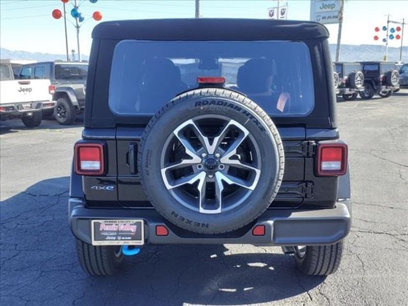 2024 Jeep Wrangler Sport S 4xe in a Black Clear Coat exterior color and Blackinterior. Perris Valley Auto Center 951-657-6100 perrisvalleyautocenter.com 