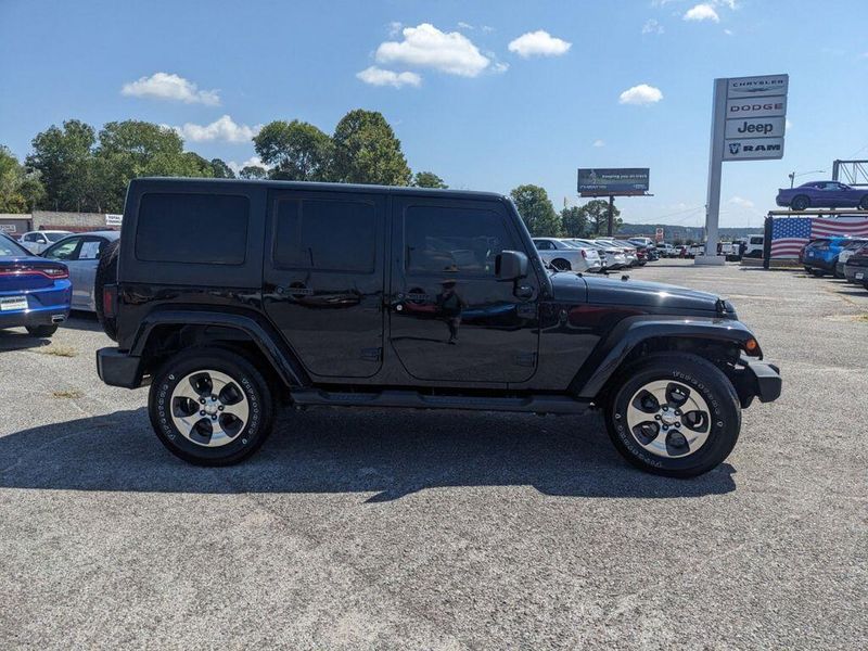 2017 Jeep Wrangler Unlimited Sahara in a Black Clear Coat exterior color and Blackinterior. Johnson Dodge 601-693-6343 pixelmotiondemo.com 