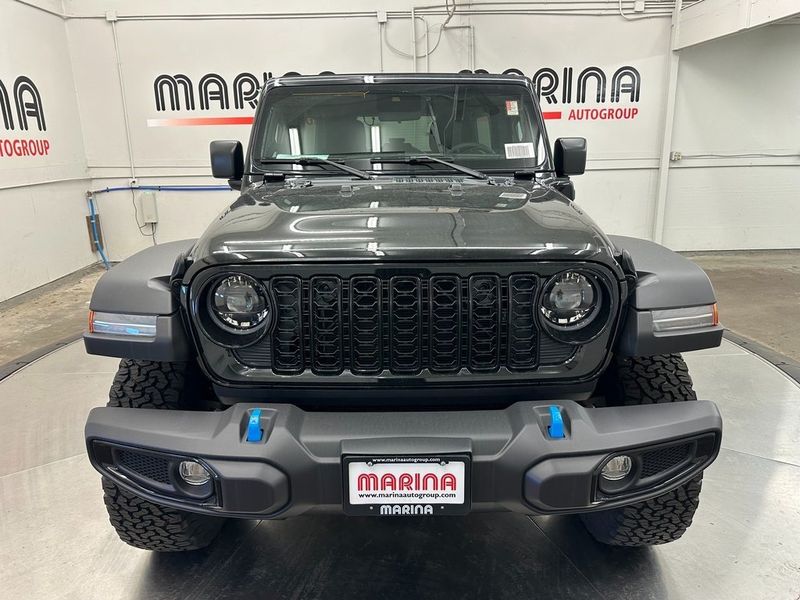 2024 Jeep Wrangler 4-door Willys 4xe in a Black Clear Coat exterior color and Blackinterior. Marina Auto Group (855) 564-8688 marinaautogroup.com 