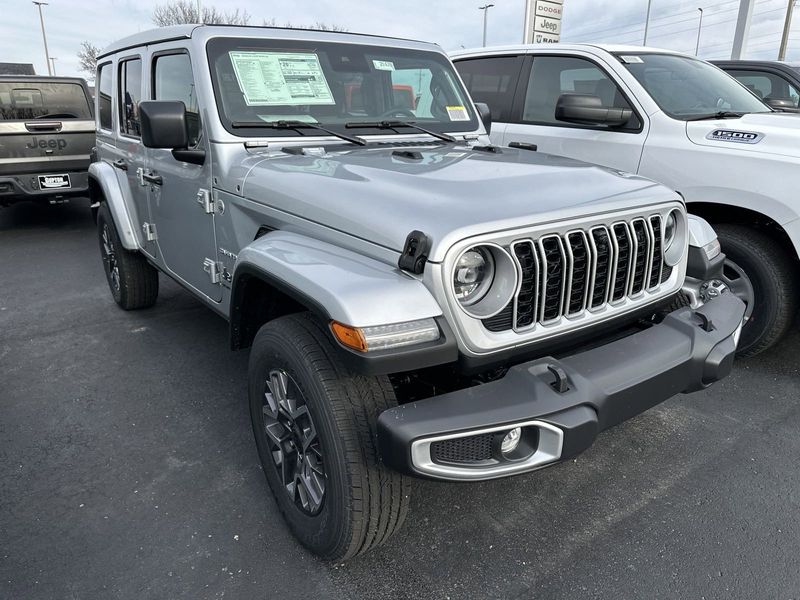 2024 Jeep Wrangler 4-door Sahara in a Silver Zynith Clear Coat exterior color and Blackinterior. CDJR of Anytown 949-555-4321 pixelmotiondemo.com 