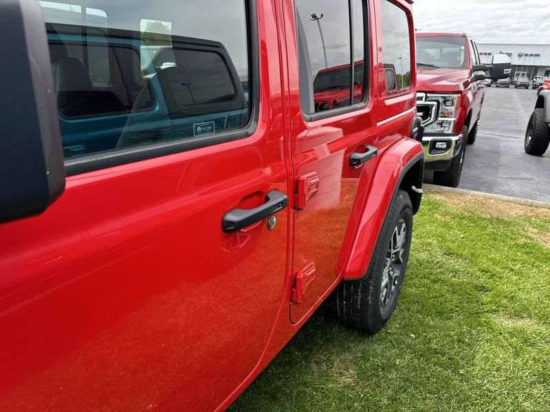 2024 Jeep Wrangler 4-door Sahara in a Firecracker Red Clear Coat exterior color. Gupton Motors Inc 615-384-2886 guptonmotors.com 