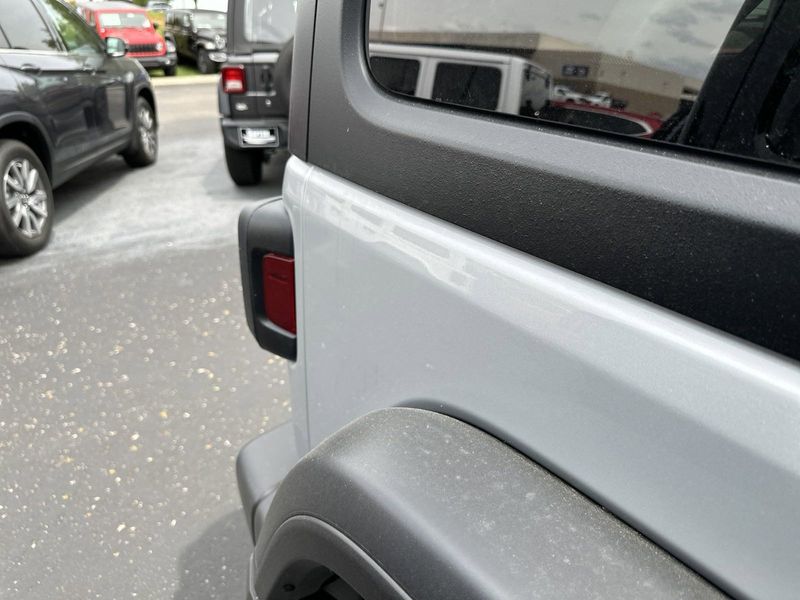 2024 Jeep Wrangler 4-door Willys in a Silver Zynith Clear Coat exterior color and Blackinterior. CDJR of Anytown 949-555-4321 pixelmotiondemo.com 