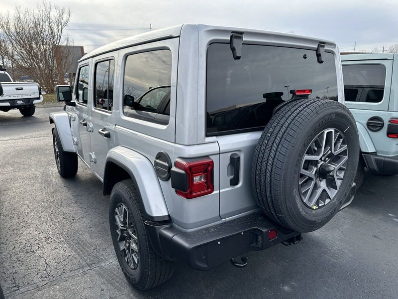 2024 Jeep Wrangler 4-door Sahara in a Silver Zynith Clear Coat exterior color and Blackinterior. CDJR of Anytown 949-555-4321 pixelmotiondemo.com 