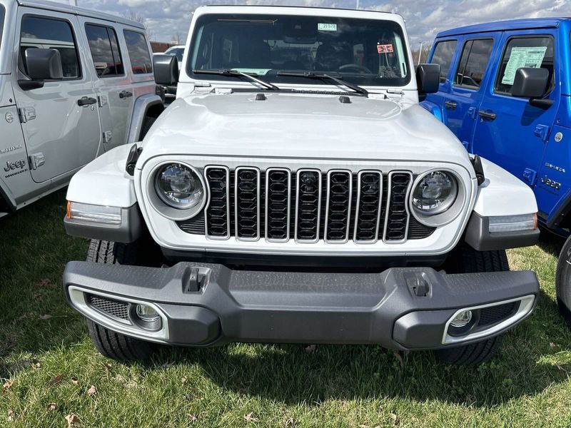 2024 Jeep Wrangler 4-door Sahara in a Bright White Clear Coat exterior color. Gupton Motors Inc 615-384-2886 guptonmotors.com 