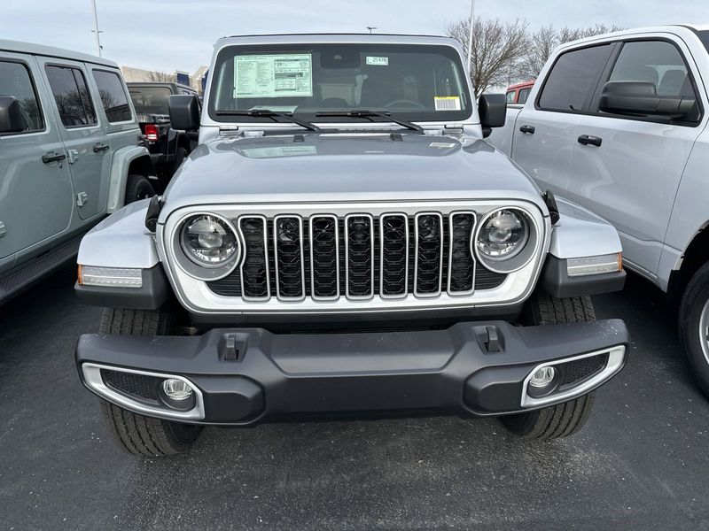 2024 Jeep Wrangler 4-door Sahara in a Silver Zynith Clear Coat exterior color and Blackinterior. CDJR of Anytown 949-555-4321 pixelmotiondemo.com 