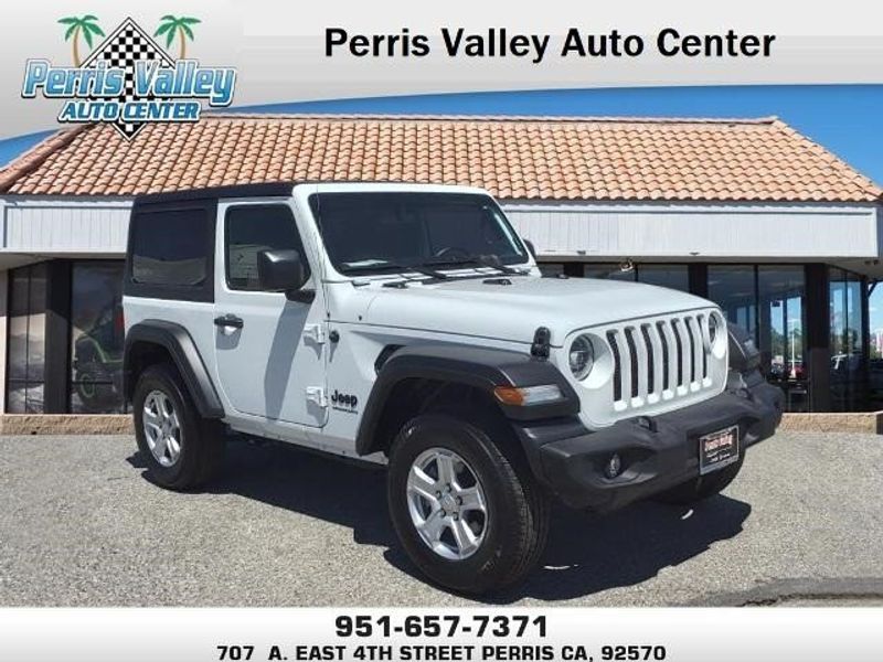 2022 Jeep Wrangler Sport S in a Bright White Clear Coat exterior color and Blackinterior. Perris Valley Kia 951-657-6100 perrisvalleykia.com 