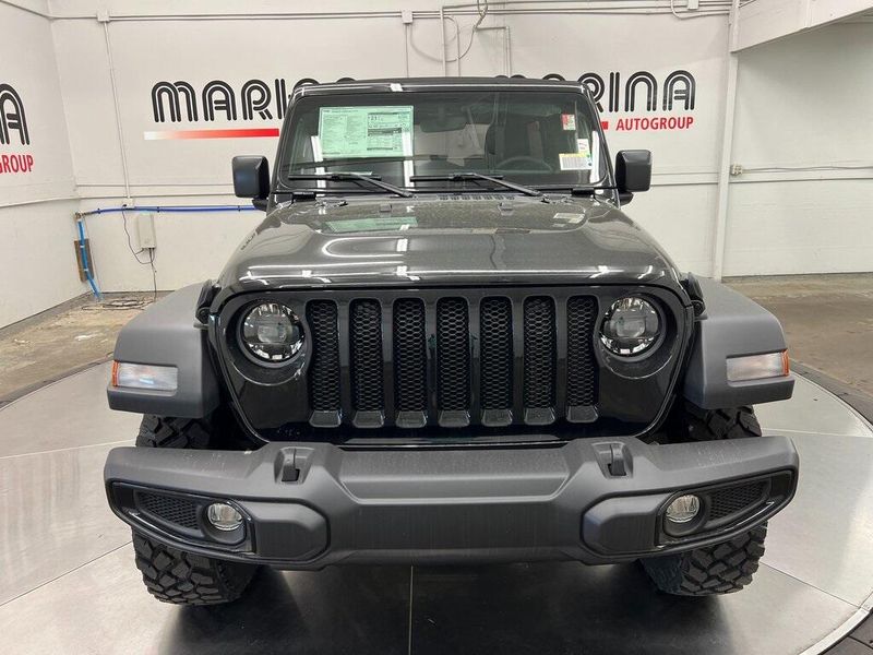 2023 Jeep Wrangler 4-door Willys 4x4 in a Black Clear Coat exterior color and Blackinterior. Marina Chrysler Dodge Jeep RAM (855) 616-8084 marinadodgeny.com 