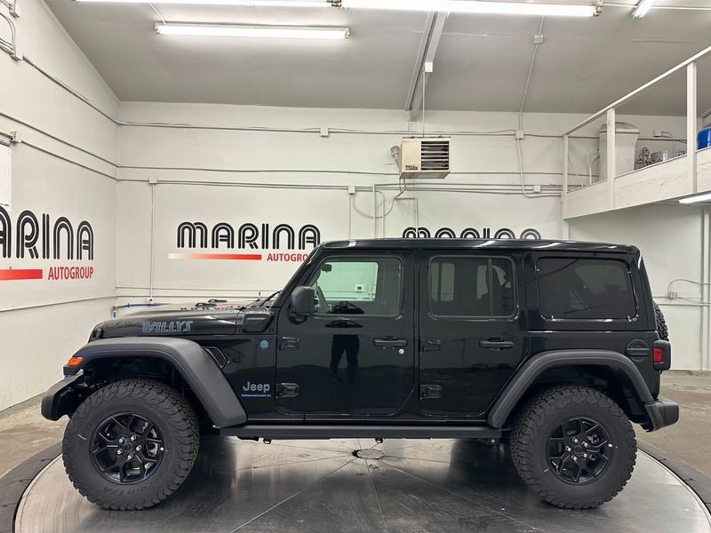 2024 Jeep Wrangler 4-door Willys 4xe in a Black Clear Coat exterior color and Blackinterior. Marina Auto Group (855) 564-8688 marinaautogroup.com 