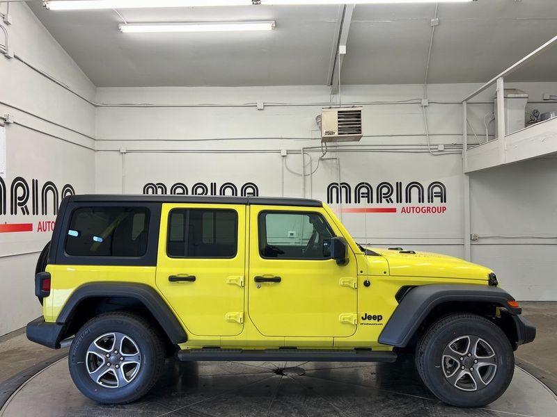 2023 Jeep Wrangler 4-door Sport S 4x4 in a High Velocity Clear Coat exterior color and Blackinterior. Marina Chrysler Dodge Jeep RAM (855) 616-8084 marinadodgeny.com 