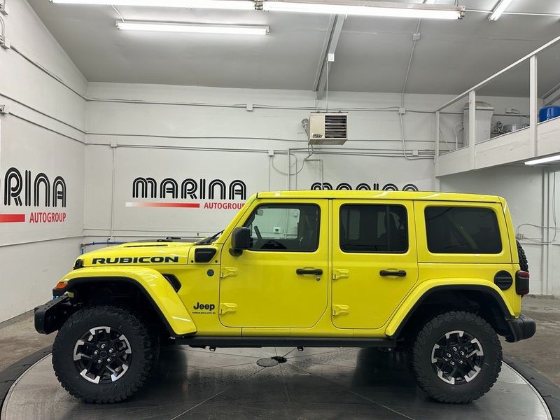 2024 Jeep Wrangler 4-door Rubicon X 4xe in a High Velocity Clear Coat exterior color and Blackinterior. Marina Auto Group (855) 564-8688 marinaautogroup.com 