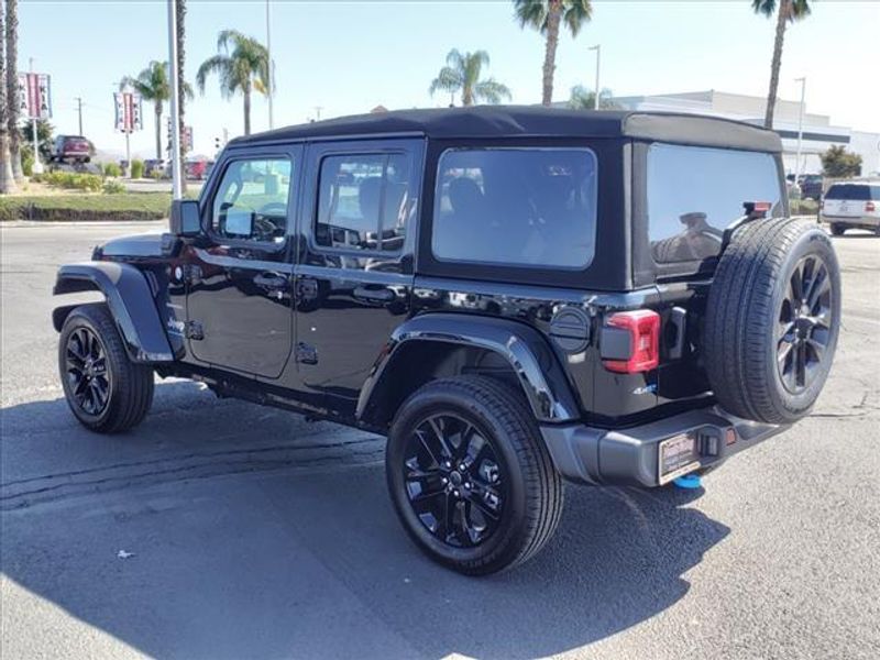 2024 Jeep Wrangler Sahara 4xe in a Black Clear Coat exterior color and Blackinterior. Perris Valley Auto Center 951-657-6100 perrisvalleyautocenter.com 