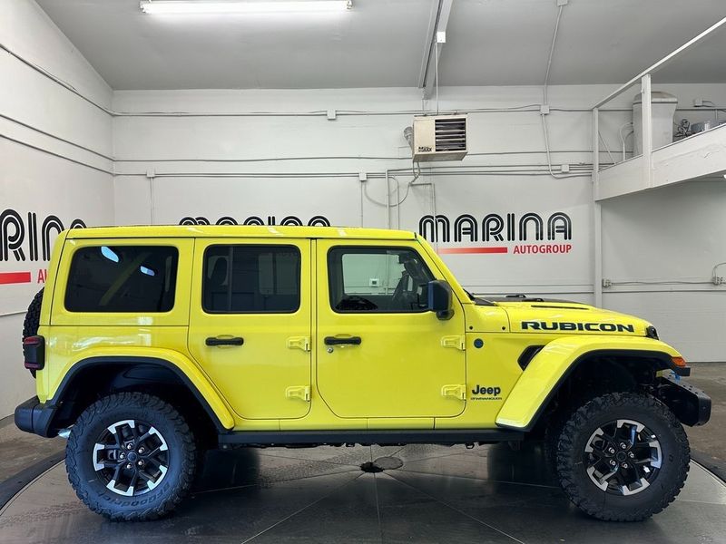 2024 Jeep Wrangler 4-door Rubicon X 4xe in a High Velocity Clear Coat exterior color and Blackinterior. Marina Chrysler Dodge Jeep RAM (855) 616-8084 marinadodgeny.com 