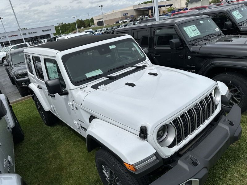 2024 Jeep Wrangler 4-door Sahara in a Bright White Clear Coat exterior color. Gupton Motors Inc 615-384-2886 guptonmotors.com 