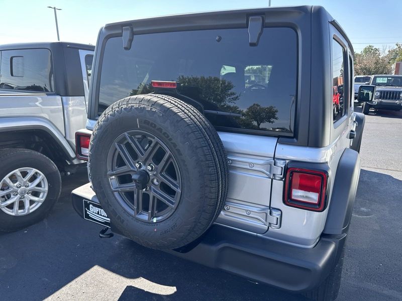 2024 Jeep Wrangler 4-door Sport S in a Silver Zynith Clear Coat exterior color and Blackinterior. CDJR of Anytown 949-555-4321 pixelmotiondemo.com 