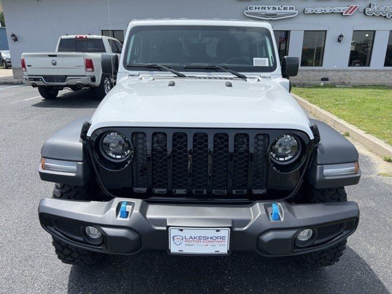 2023 Jeep Wrangler Willys 4xe in a Bright White Clear Coat exterior color and Blackinterior. Lakeshore CDJR Seaford 302-213-6058 lakeshorecdjr.com 