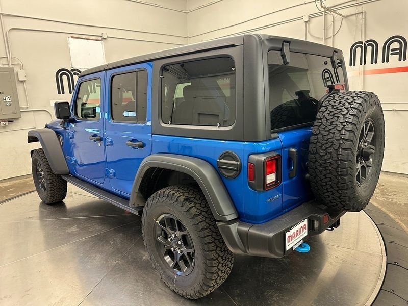 2024 Jeep Wrangler 4-door Willys 4xe in a Hydro Blue Pearl Coat exterior color and Blackinterior. Marina Chrysler Dodge Jeep RAM (855) 616-8084 marinadodgeny.com 