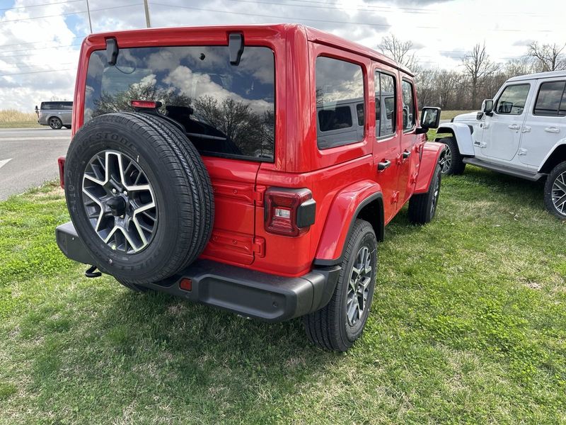 2024 Jeep Wrangler 4-door Sahara in a Firecracker Red Clear Coat exterior color. Gupton Motors Inc 615-384-2886 guptonmotors.com 