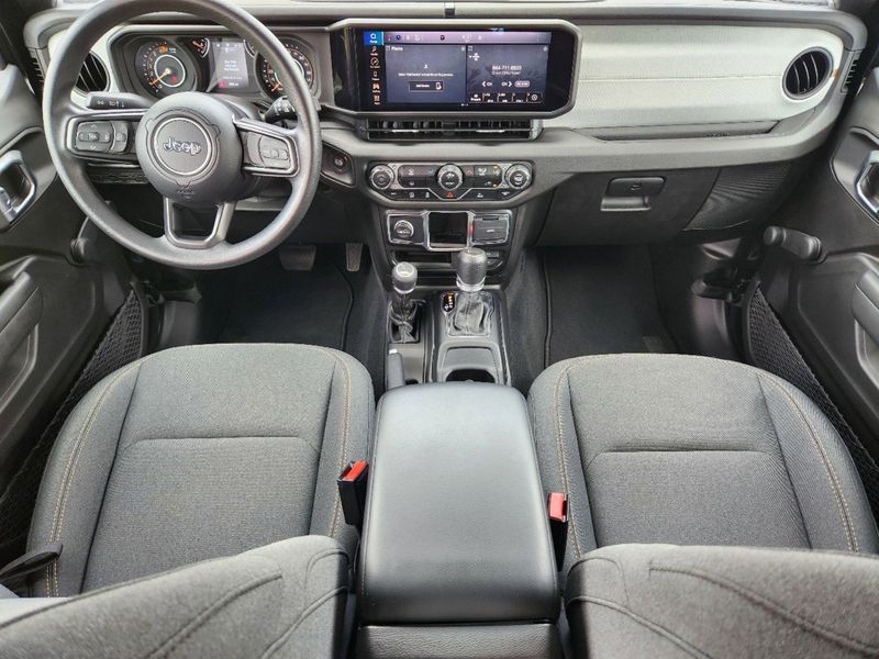 2024 Jeep Wrangler 4-door Sport in a Black Clear Coat exterior color and Blackinterior. Elder Chrysler Dodge Jeep Ram 9032920419 elderchryslerdodgejeep.com 