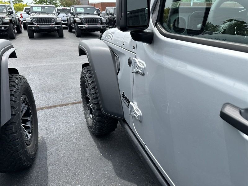 2024 Jeep Wrangler 4-door Willys in a Silver Zynith Clear Coat exterior color and Blackinterior. CDJR of Anytown 949-555-4321 pixelmotiondemo.com 