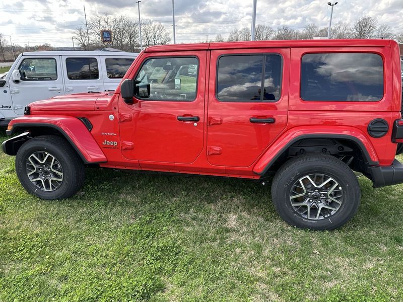 2024 Jeep Wrangler 4-door Sahara in a Firecracker Red Clear Coat exterior color. Gupton Motors Inc 615-384-2886 guptonmotors.com 