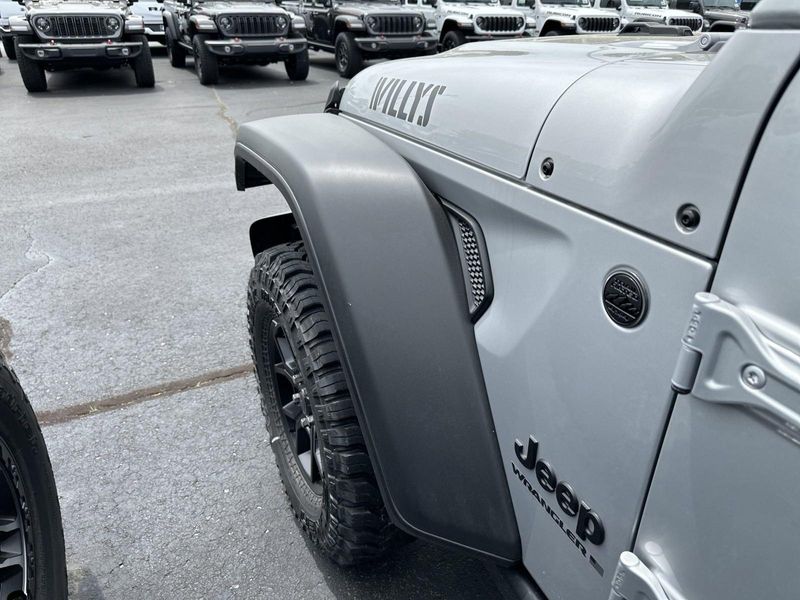 2024 Jeep Wrangler 4-door Willys in a Silver Zynith Clear Coat exterior color and Blackinterior. CDJR of Anytown 949-555-4321 pixelmotiondemo.com 