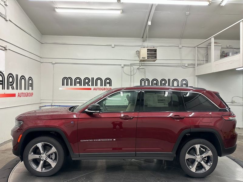 2024 Jeep Grand Cherokee 4xe in a Velvet Red Pearl Coat exterior color and Wicker Beige/Global Blackinterior. Marina Auto Group (855) 564-8688 marinaautogroup.com 