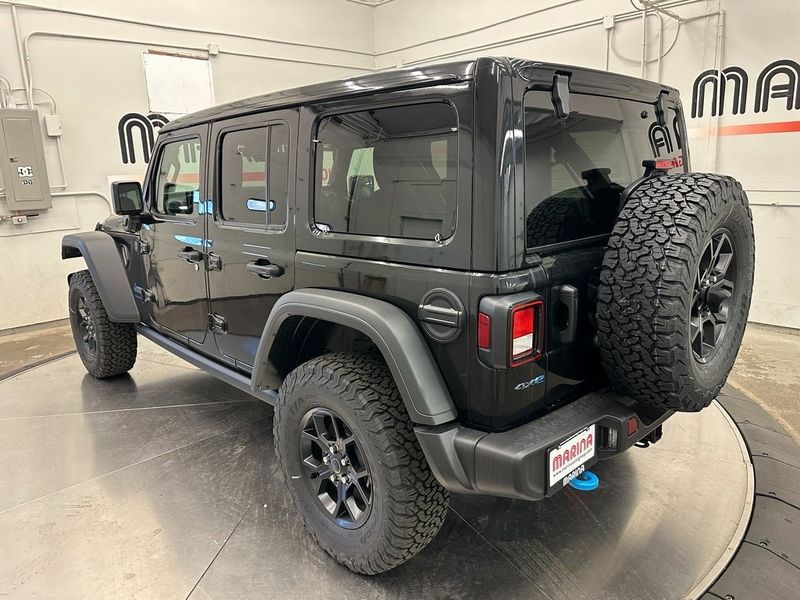 2024 Jeep Wrangler 4-door Willys 4xe in a Black Clear Coat exterior color and Blackinterior. Marina Auto Group (855) 564-8688 marinaautogroup.com 