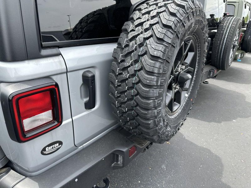 2024 Jeep Wrangler 4-door Willys in a Silver Zynith Clear Coat exterior color and Blackinterior. CDJR of Anytown 949-555-4321 pixelmotiondemo.com 