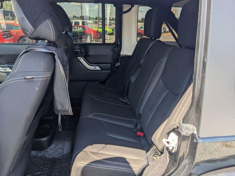 2017 Jeep Wrangler Unlimited Sahara in a Black Clear Coat exterior color and Blackinterior. Johnson Dodge 601-693-6343 pixelmotiondemo.com 