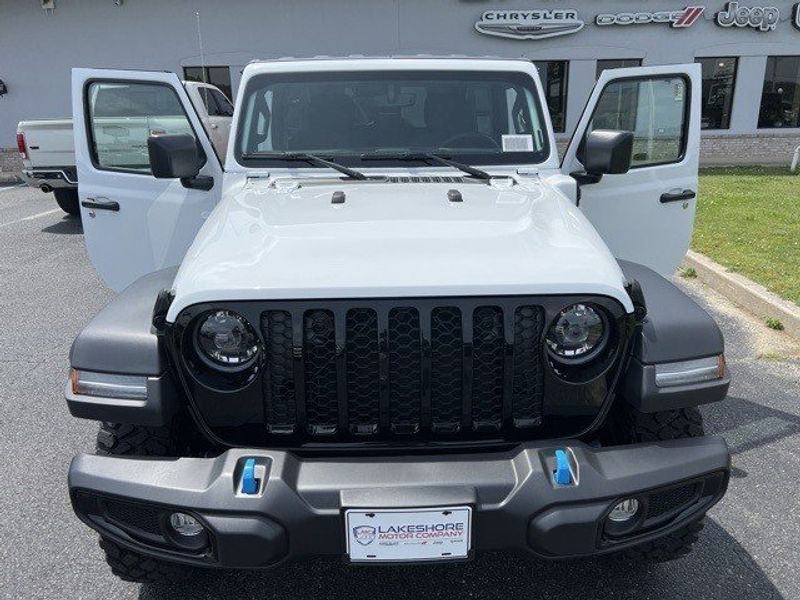 2023 Jeep Wrangler Willys 4xe in a Bright White Clear Coat exterior color and Blackinterior. Lakeshore CDJR Seaford 302-213-6058 lakeshorecdjr.com 