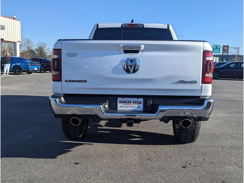 2021 RAM 1500 Laramie in a Bright White Clear Coat exterior color and Light Frost Beige/Mountain Browninterior. Johnson Dodge 601-693-6343 pixelmotiondemo.com 