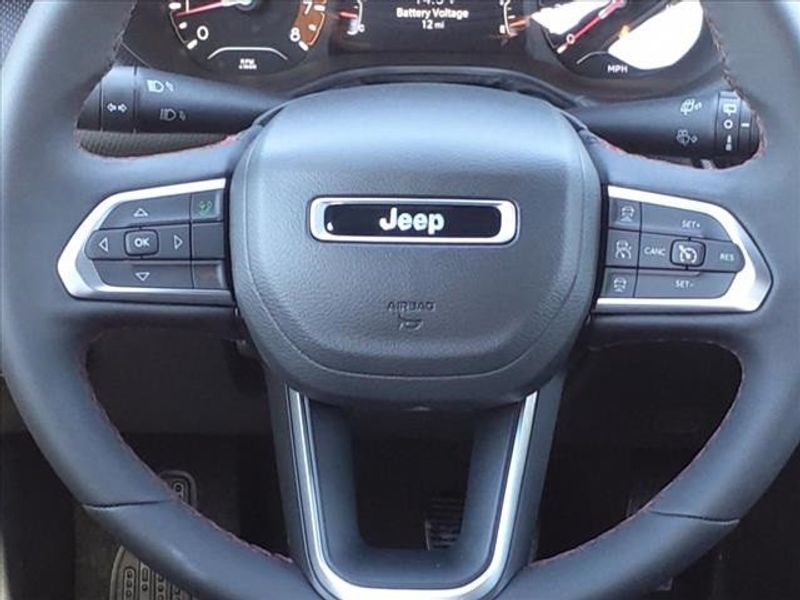 2024 Jeep Compass Trailhawk in a Bright White Clear Coat exterior color and Ruby Red/Blackinterior. Perris Valley Auto Center 951-657-6100 perrisvalleyautocenter.com 