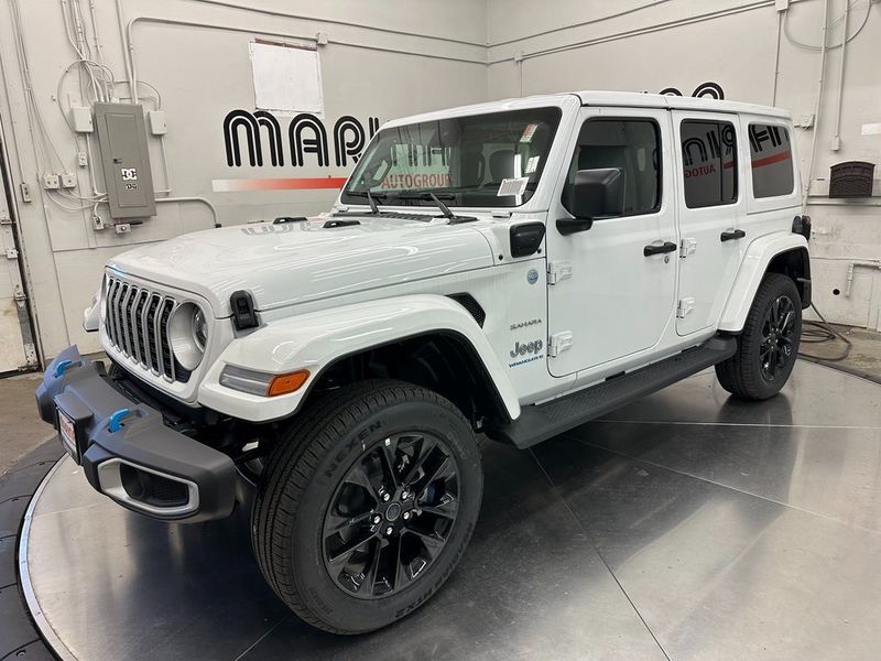 2024 Jeep Wrangler 4-door Sahara 4xe in a Bright White Clear Coat exterior color. Marina Auto Group (855) 564-8688 marinaautogroup.com 