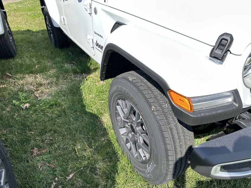 2024 Jeep Wrangler 4-door Sahara in a Bright White Clear Coat exterior color. Gupton Motors Inc 615-384-2886 guptonmotors.com 