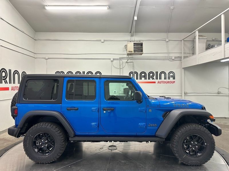 2024 Jeep Wrangler 4-door Willys 4xe in a Hydro Blue Pearl Coat exterior color and Blackinterior. Marina Chrysler Dodge Jeep RAM (855) 616-8084 marinadodgeny.com 