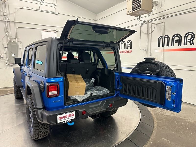 2024 Jeep Wrangler 4-door Willys 4xe in a Hydro Blue Pearl Coat exterior color and Blackinterior. Marina Chrysler Dodge Jeep RAM (855) 616-8084 marinadodgeny.com 