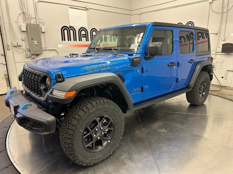 2024 Jeep Wrangler 4-door Willys 4xe in a Hydro Blue Pearl Coat exterior color and Blackinterior. Marina Auto Group (855) 564-8688 marinaautogroup.com 