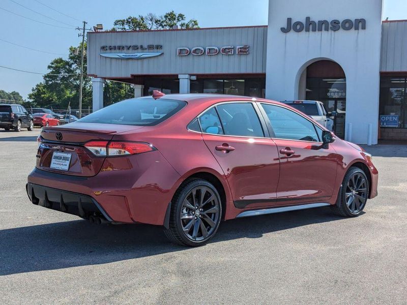 2023 Toyota Corolla SE in a Ruby Flare Pearl exterior color and Black/Redinterior. Johnson Dodge 601-693-6343 pixelmotiondemo.com 