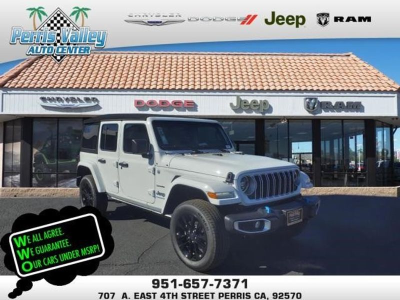 2024 Jeep Wrangler Sahara 4xe in a Bright White Clear Coat exterior color and Blackinterior. Perris Valley Auto Center 951-657-6100 perrisvalleyautocenter.com 