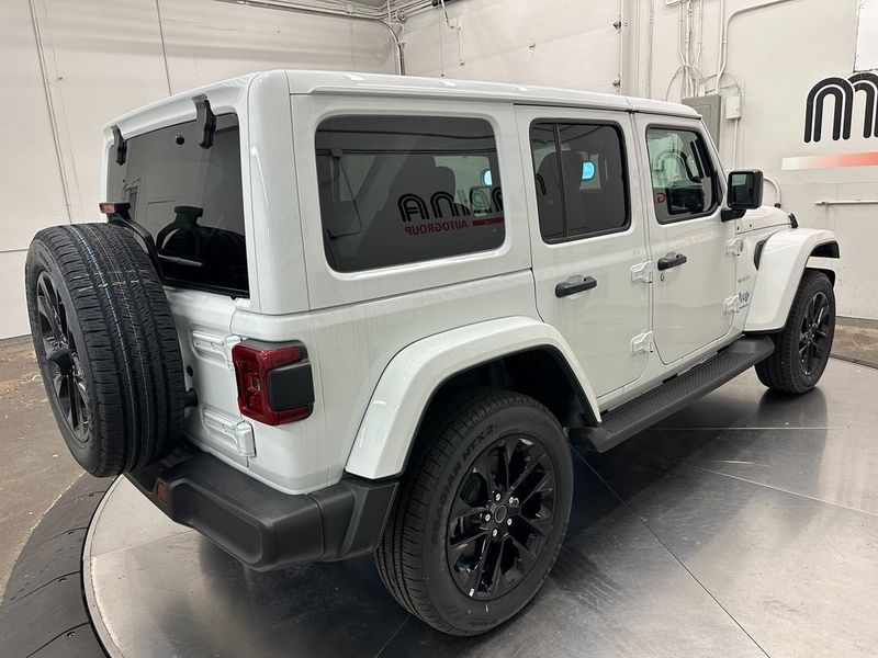 2024 Jeep Wrangler 4-door Sahara 4xe in a Bright White Clear Coat exterior color. Marina Auto Group (855) 564-8688 marinaautogroup.com 