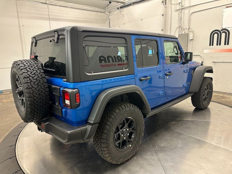 2024 Jeep Wrangler 4-door Willys 4xe in a Hydro Blue Pearl Coat exterior color and Blackinterior. Marina Auto Group (855) 564-8688 marinaautogroup.com 