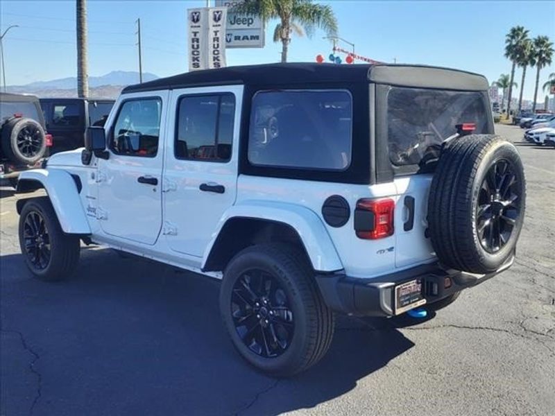 2024 Jeep Wrangler Sahara 4xe in a Bright White Clear Coat exterior color and Blackinterior. Perris Valley Auto Center 951-657-6100 perrisvalleyautocenter.com 