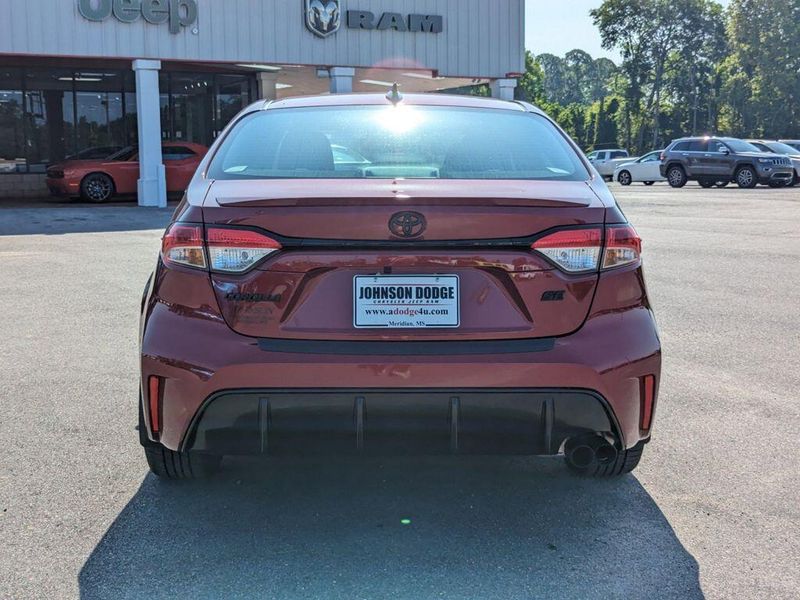 2023 Toyota Corolla SE in a Ruby Flare Pearl exterior color and Black/Redinterior. Johnson Dodge 601-693-6343 pixelmotiondemo.com 